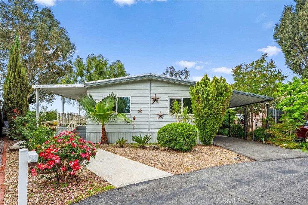 31130 South General Kearny Road, Unit 32 Temecula, CA 92591 - Photo 1 of 1 a front view of a house with a yard and potted plants