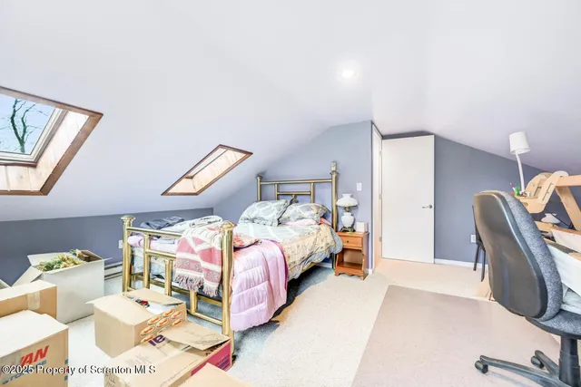 a bedroom with a bed and a large window with chair