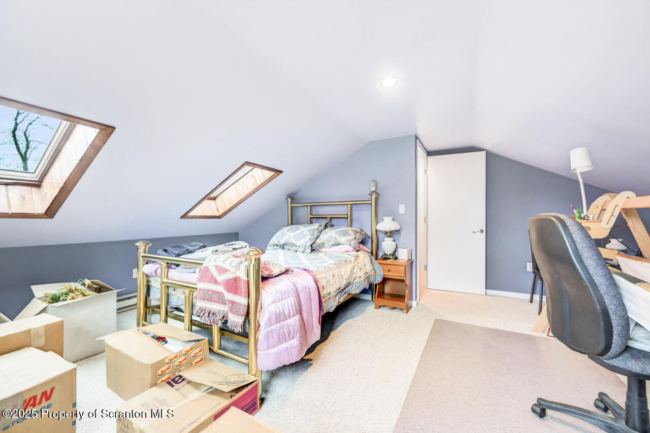 11 Mizianty Lane Waymart, PA 18472 - Photo 30 of 84 a bedroom with a bed and a lounge chair