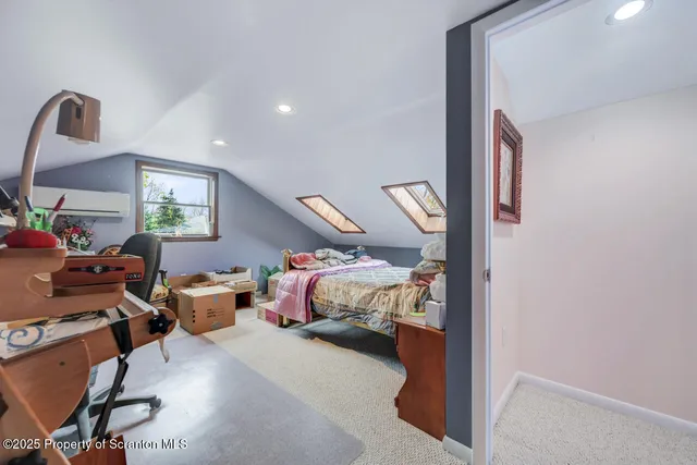 a view of a hallway with furniture and wooden floor