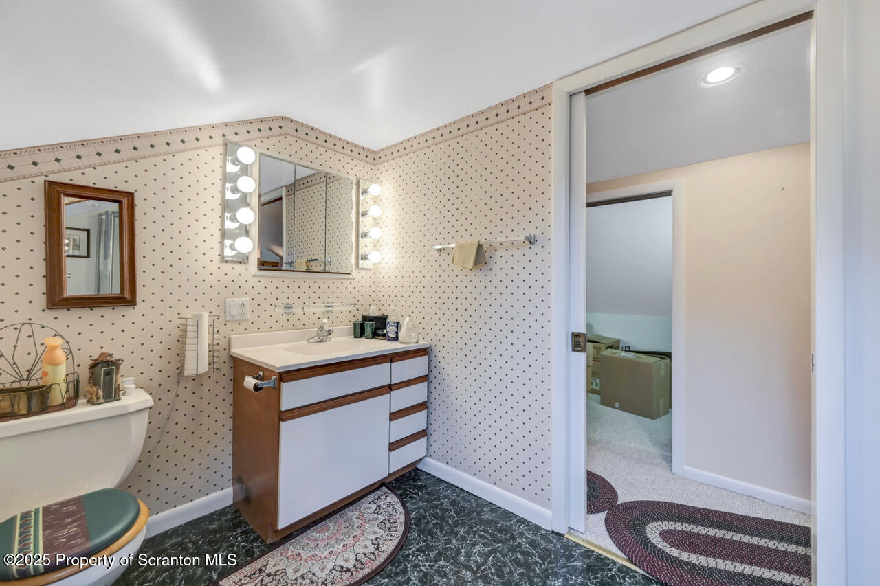 11 Mizianty Lane Waymart, PA 18472 - Photo 32 of 84 a spacious bathroom with a granite countertop sink and a mirror