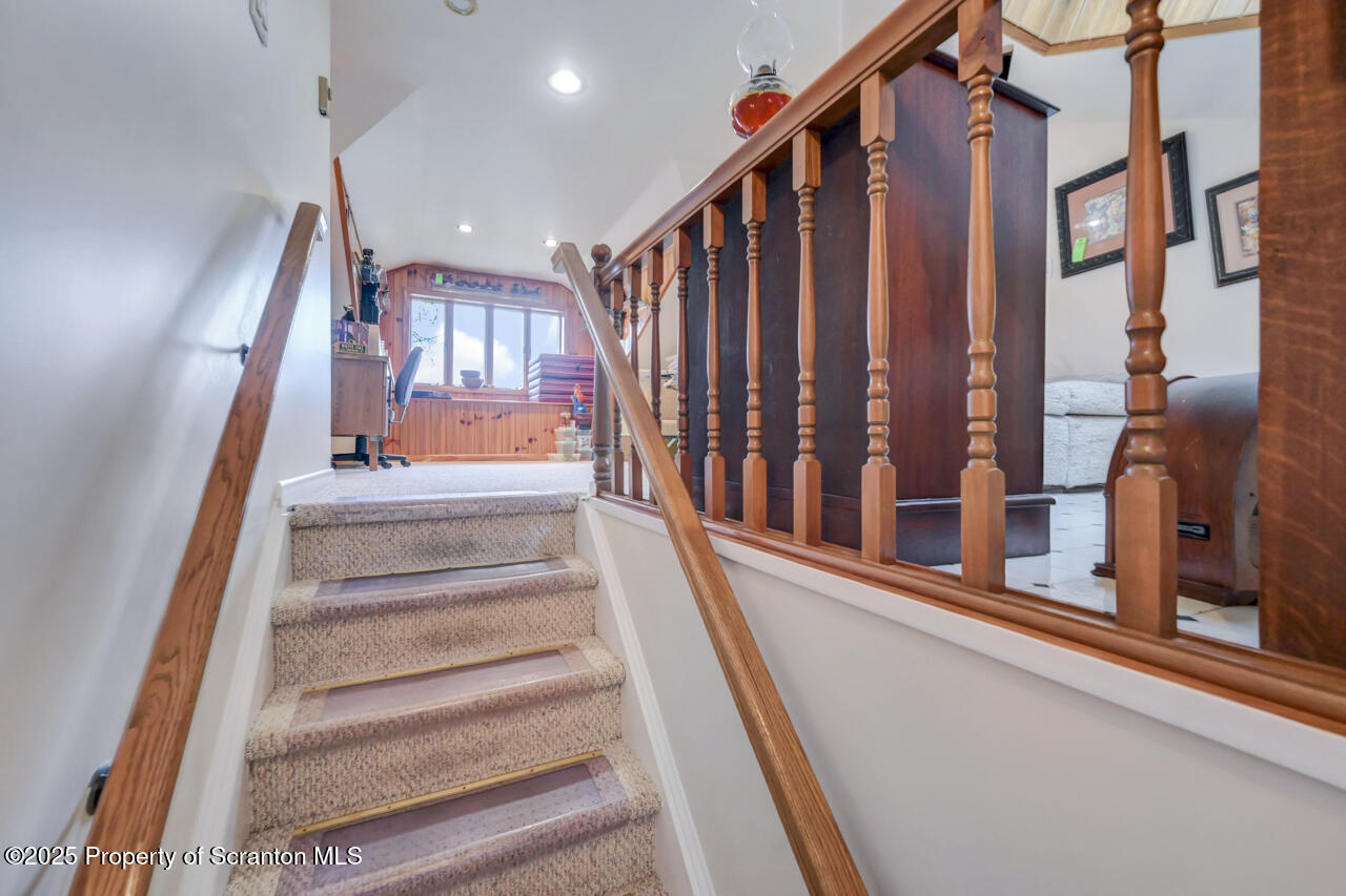 11 Mizianty Lane Waymart, PA 18472 - Photo 48 of 84 a view of staircase with lots of frames on wall and a large window