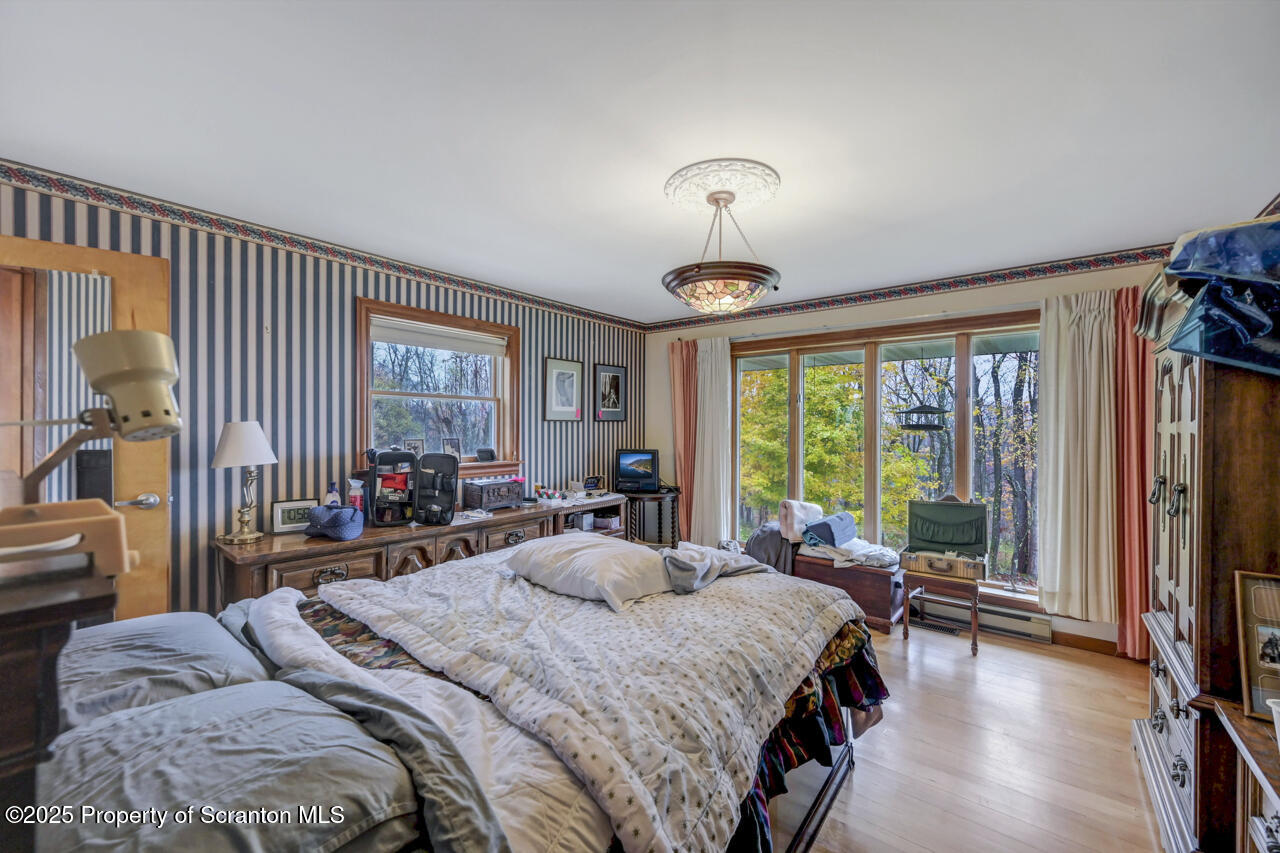 11 Mizianty Lane Waymart, PA 18472 - Photo 58 of 84 a bedroom with a bed and a large window with chair