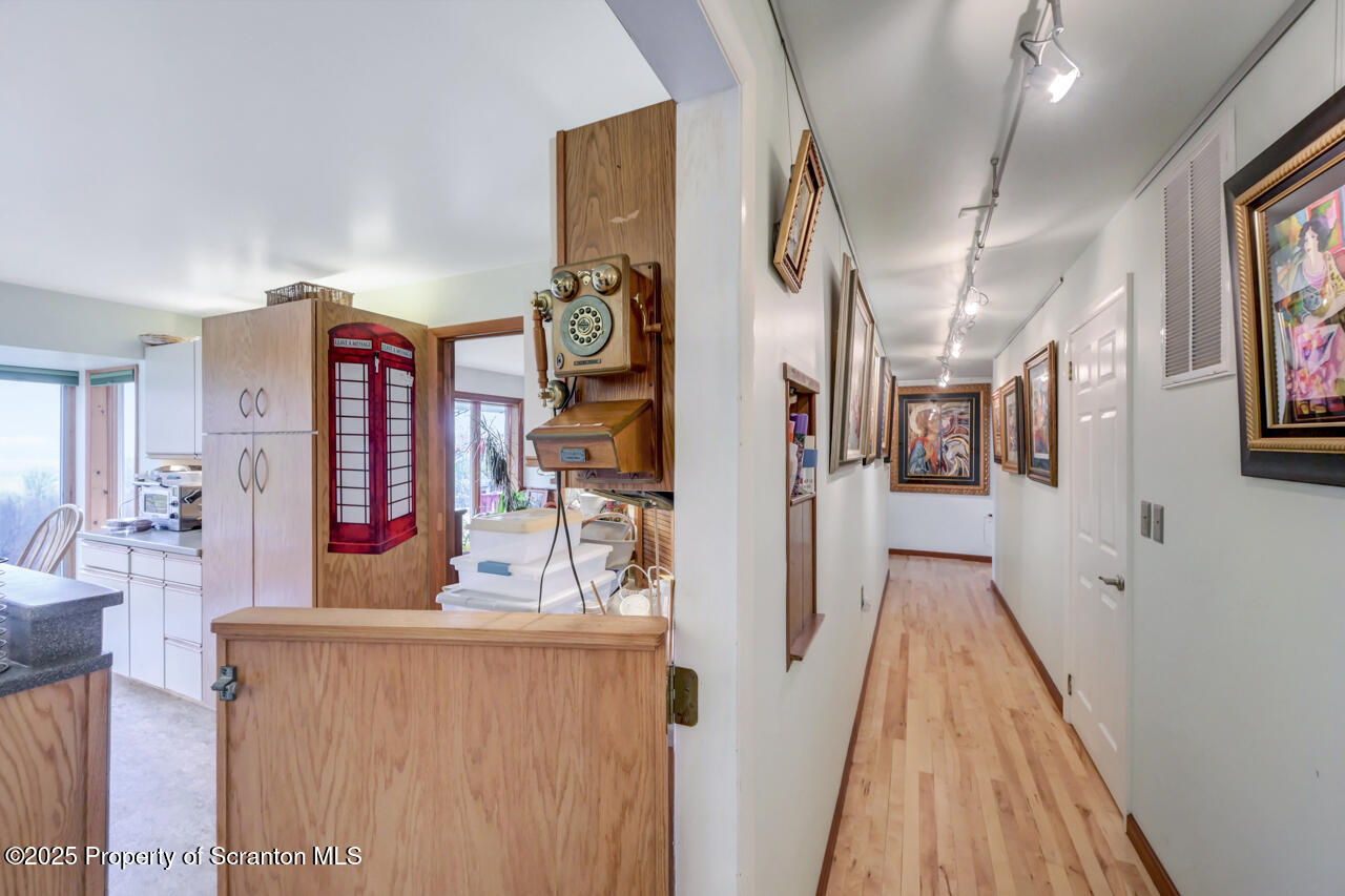 11 Mizianty Lane Waymart, PA 18472 - Photo 59 of 84 a view of a hallway with furniture and wooden floor
