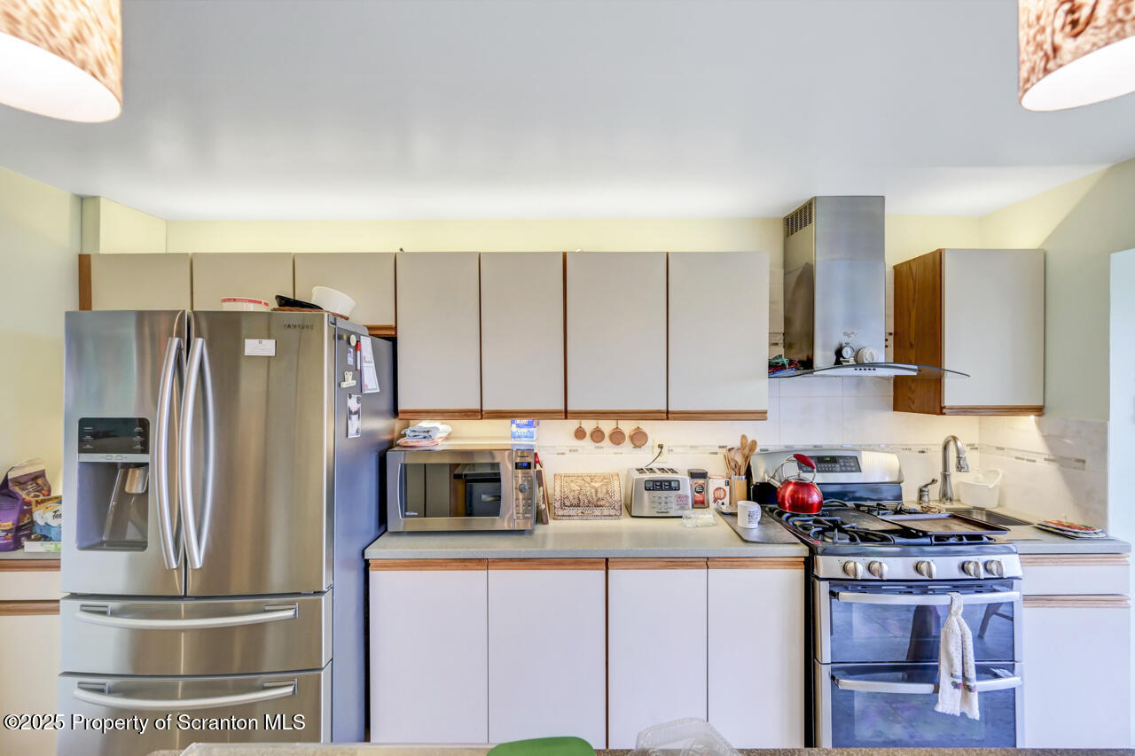 11 Mizianty Lane Waymart, PA 18472 - Photo 61 of 84 a kitchen with stainless steel appliances granite countertop a refrigerator sink and stove