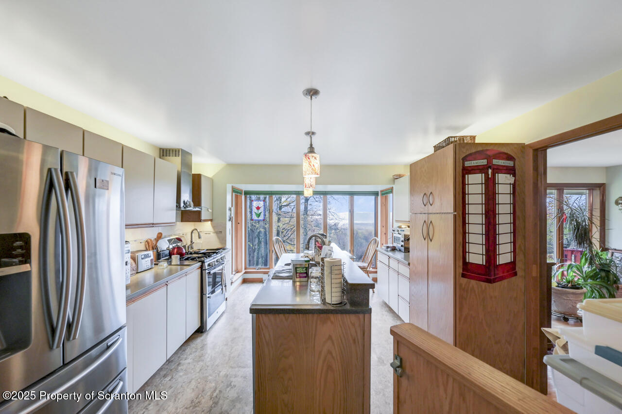 11 Mizianty Lane Waymart, PA 18472 - Photo 67 of 84 a kitchen with stainless steel appliances granite countertop a refrigerator and a view of living room