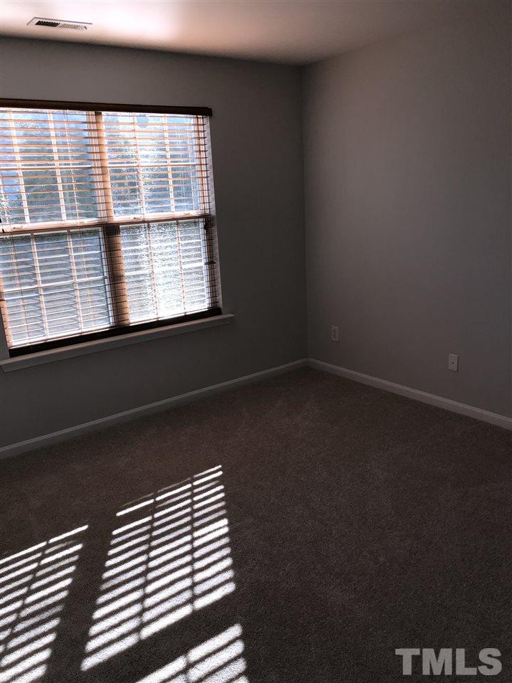 7857 Spungold Street Raleigh, NC 27617 - Photo 11 of 13 a view of a closet area with wooden floor