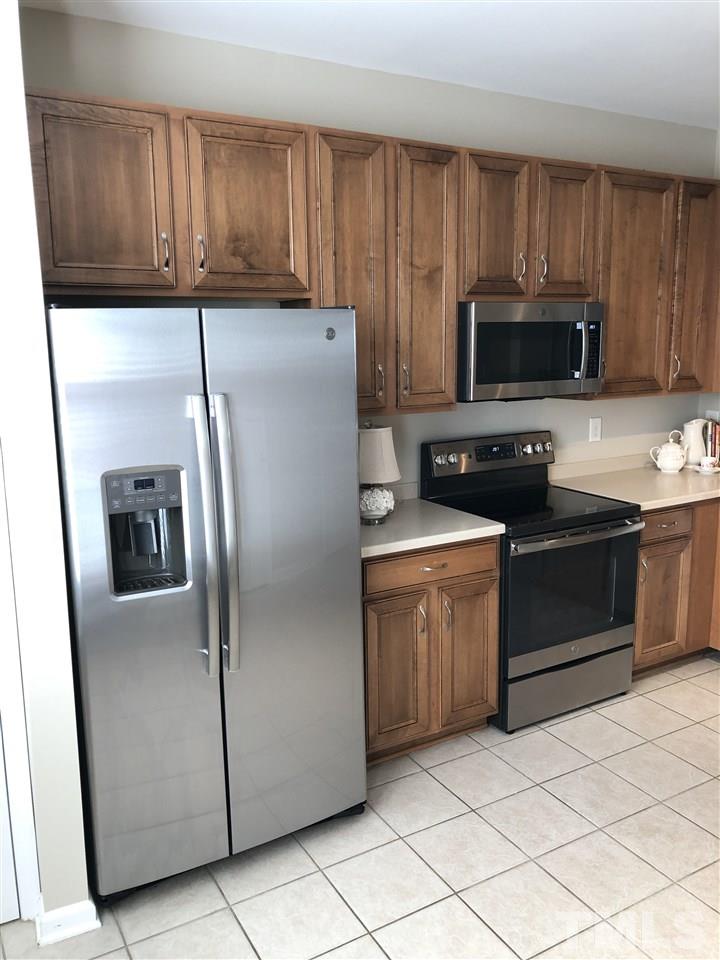 7857 Spungold Street Raleigh, NC 27617 - Photo 3 of 13 a kitchen with a refrigerator sink and microwave
