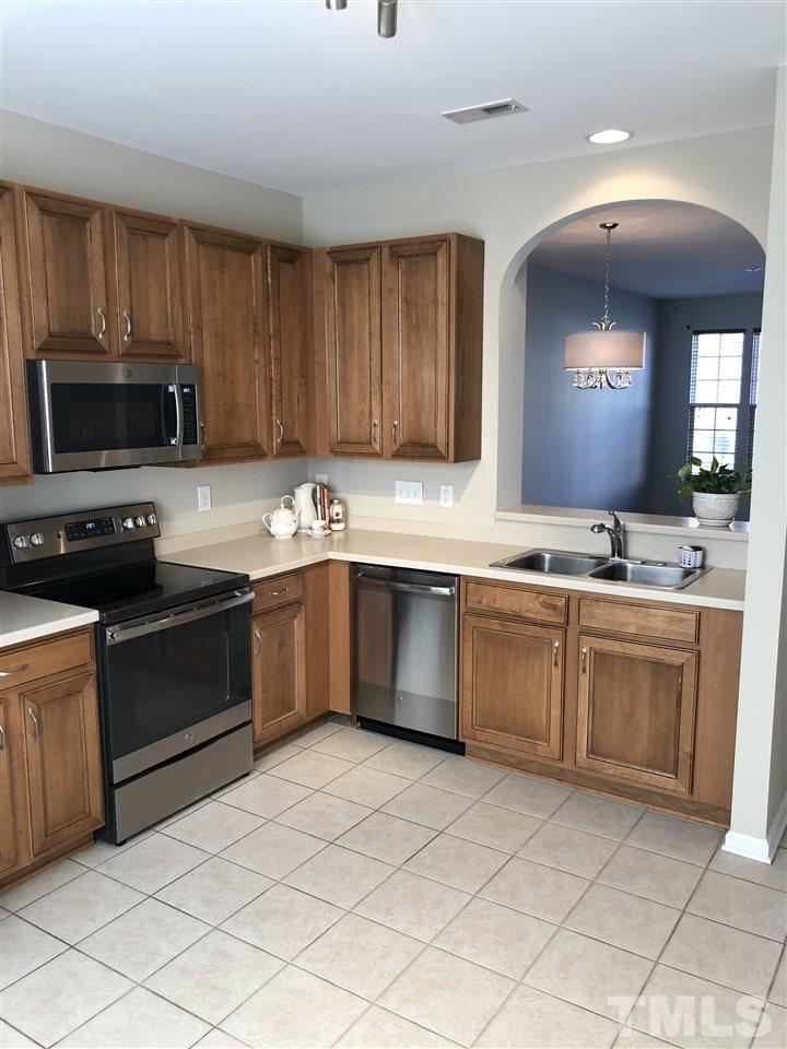 7857 Spungold Street Raleigh, NC 27617 - Photo 4 of 13 a kitchen with a sink cabinets and stainless steel appliances