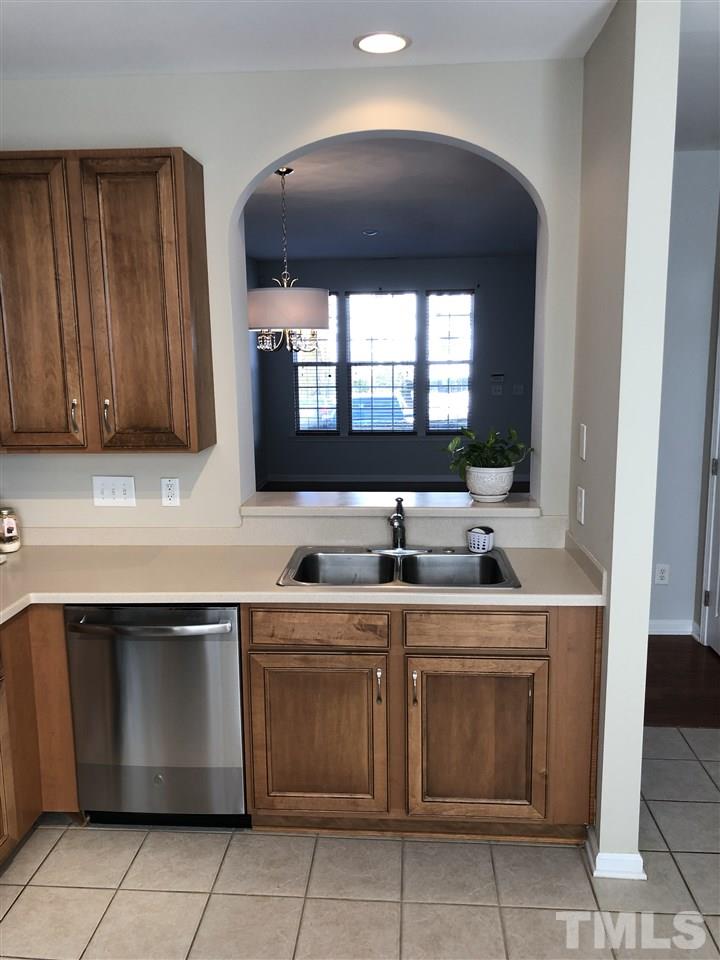 7857 Spungold Street Raleigh, NC 27617 - Photo 5 of 13 a kitchen with a sink and cabinets