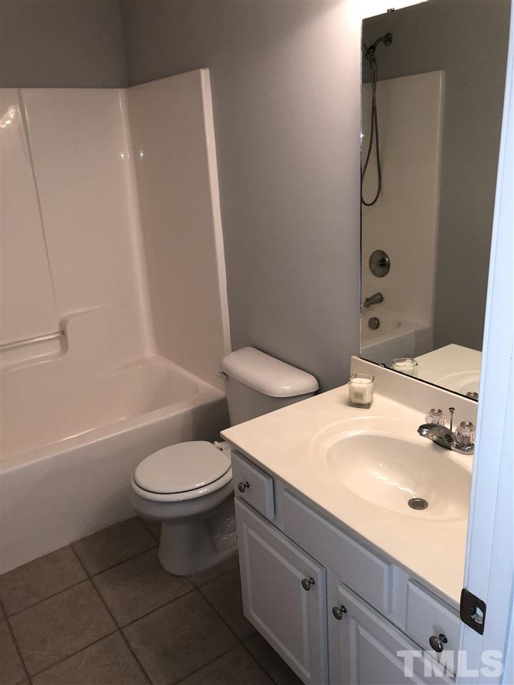 7857 Spungold Street Raleigh, NC 27617 - Photo 10 of 13 a bathroom with a sink a toilet and shower