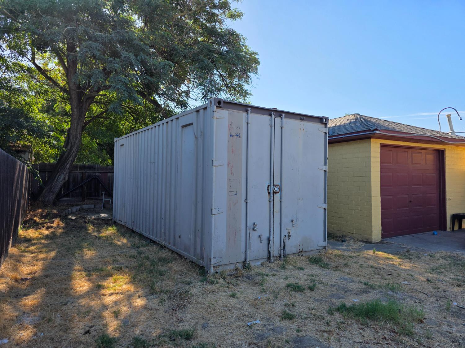 1512 Swalls Lane Modesto, CA 95358 - Photo 13 of 18 a view of a backyard with potted plants and large tree