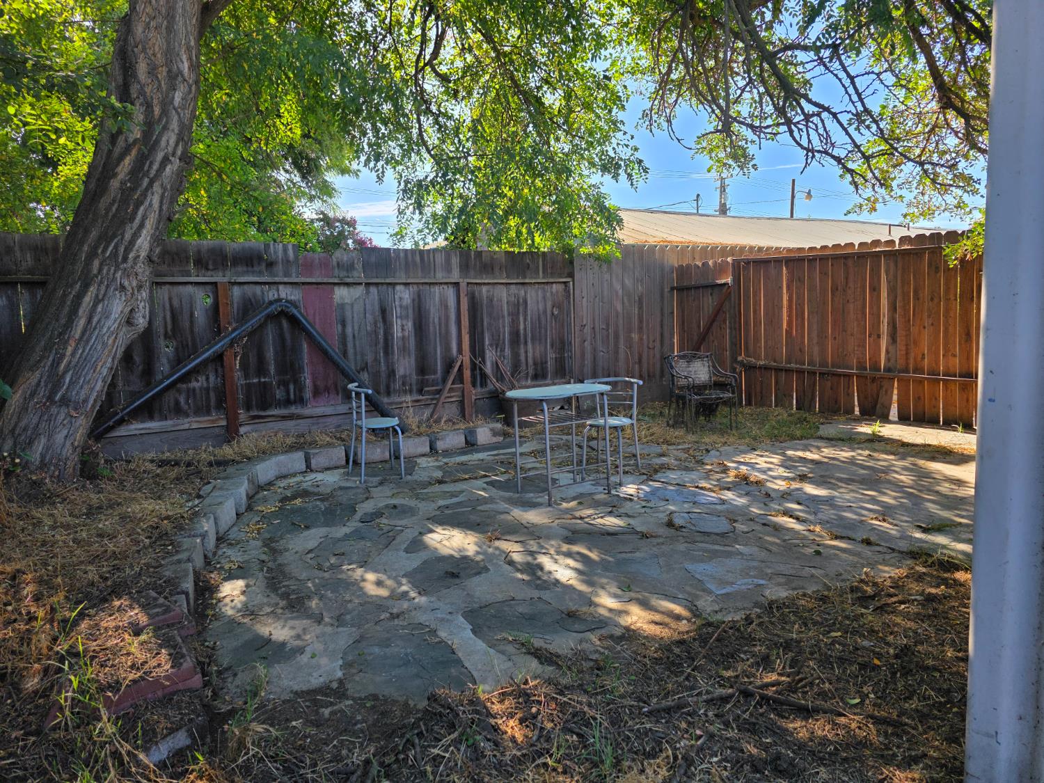 1512 Swalls Lane Modesto, CA 95358 - Photo 14 of 18 a backyard of a house with table and chairs