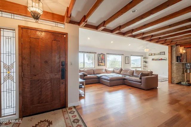 a living room with furniture and wooden floor