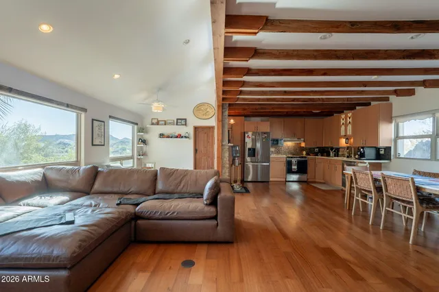 a living room with furniture and kitchen view