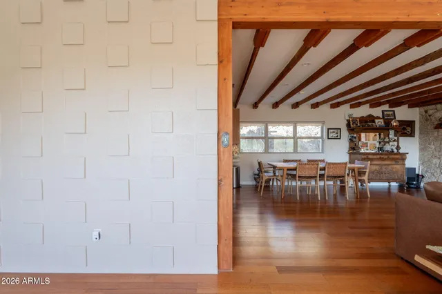 a living room with furniture and a flat screen tv next to a window