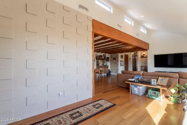 a kitchen with stainless steel appliances granite countertop a refrigerator a stove and a wooden floors