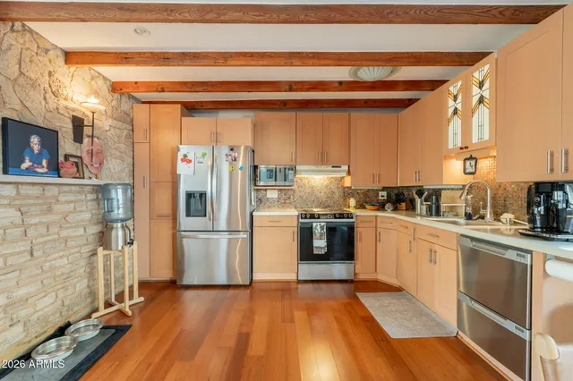a kitchen with a stove a sink and a cabinets