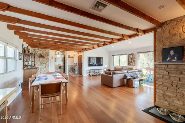 a living room with furniture a flat screen tv and kitchen view