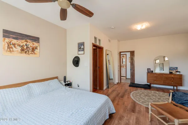 a bathroom with a granite countertop toilet sink and mirror