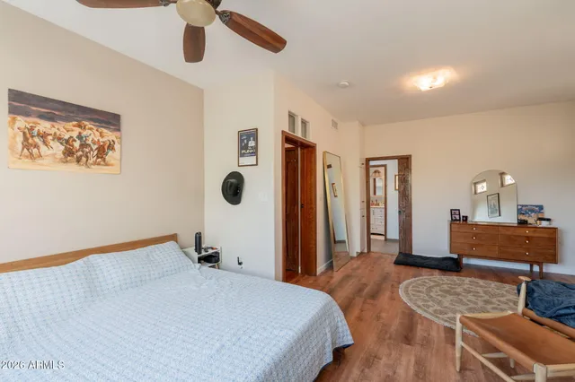 a bathroom with a granite countertop toilet sink and mirror