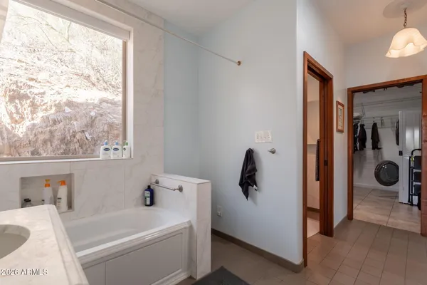 a bathroom with a granite countertop sink mirror vanity and toilet