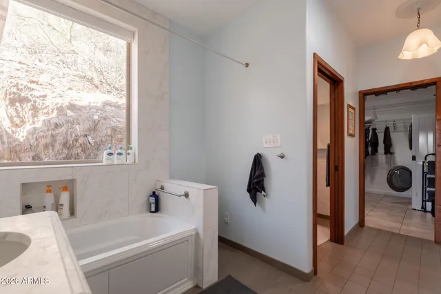 a bathroom with a granite countertop sink mirror vanity and toilet
