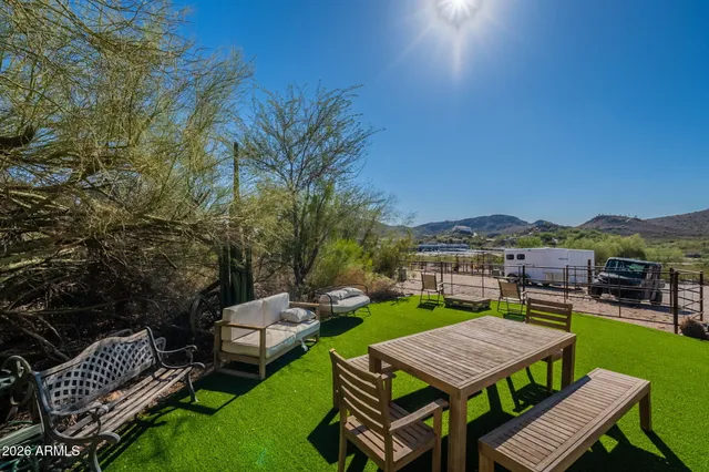 a view of a table and chairs in the garden