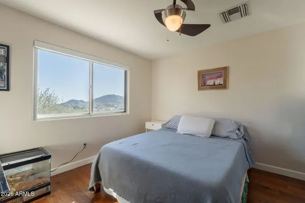a living room with furniture wooden floor and a window