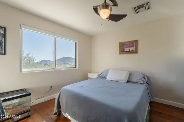 a living room with furniture wooden floor and a window