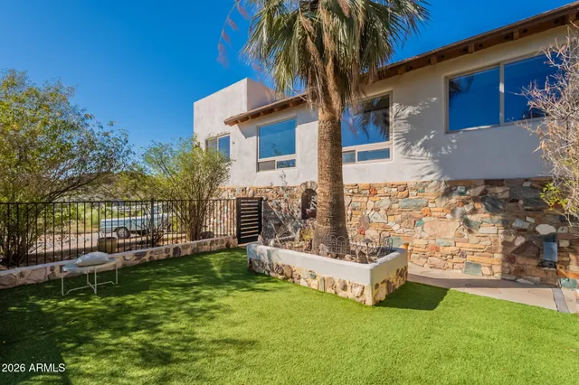 a view of a garden with wooden fence
