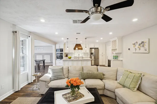 a living room with furniture and kitchen view
