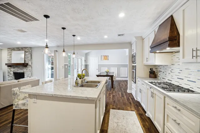 a kitchen with kitchen island granite countertop lots of counter top space and stainless steel appliances