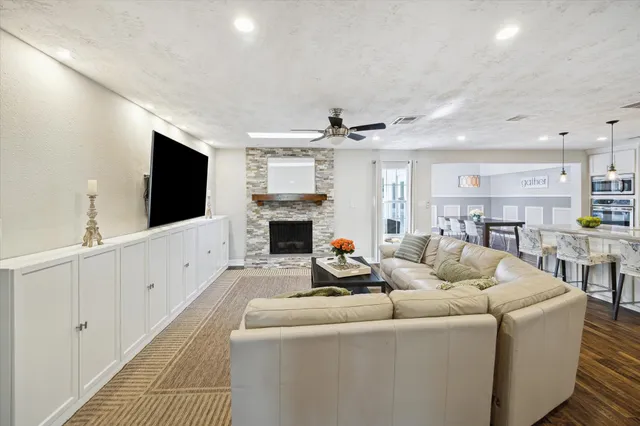 a living room with furniture a flat screen tv and a fireplace