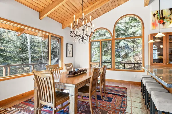a view of a dining room with furniture large windows and wooden floor