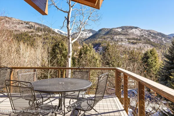a view of a balcony with a table and chairs