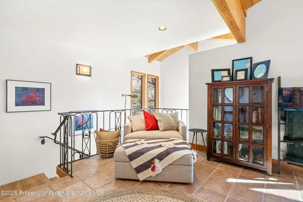 a living room with furniture and book shelf