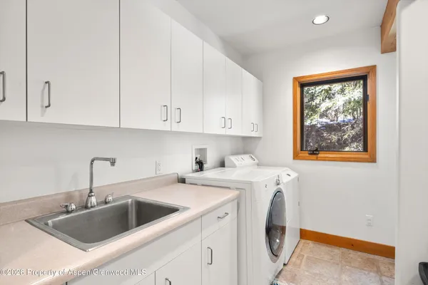 a view of a kitchen with sink and washing machine