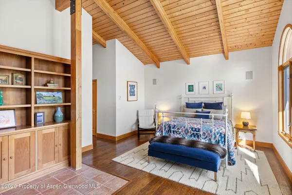 a living room with furniture and a book shelf