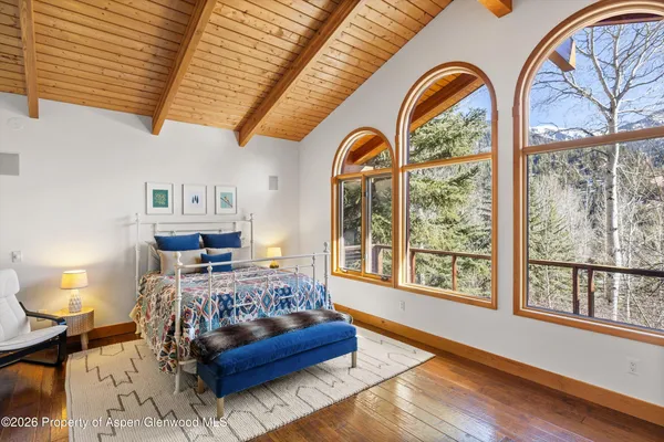 a bedroom with a bed couch and window