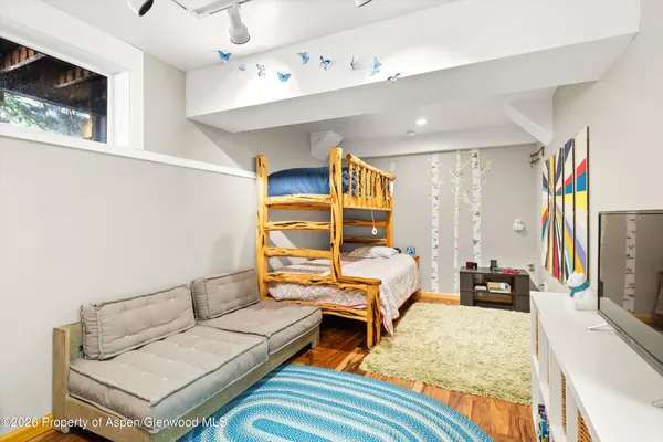a bedroom with furniture and a flat screen tv