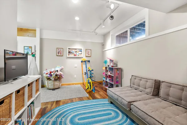a bedroom with furniture and a flat screen tv