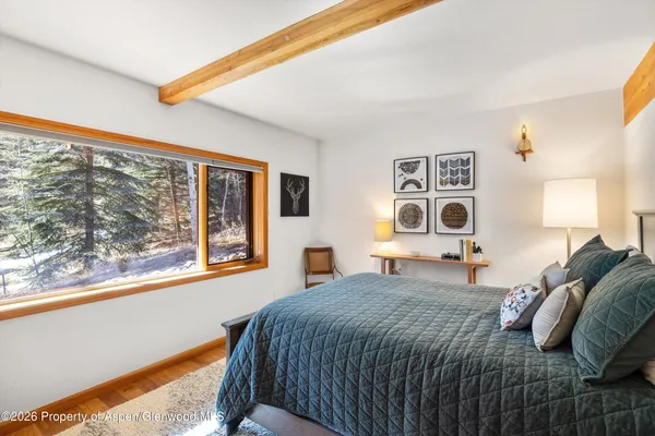a bedroom with a bed and a large window