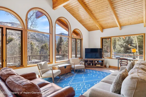 a living room with furniture and a large window