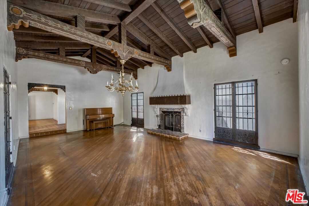 6220 Warner Drive Los Angeles, CA 90048 - Photo 12 of 44 a view of a livingroom with a fireplace a ceiling fan and windows