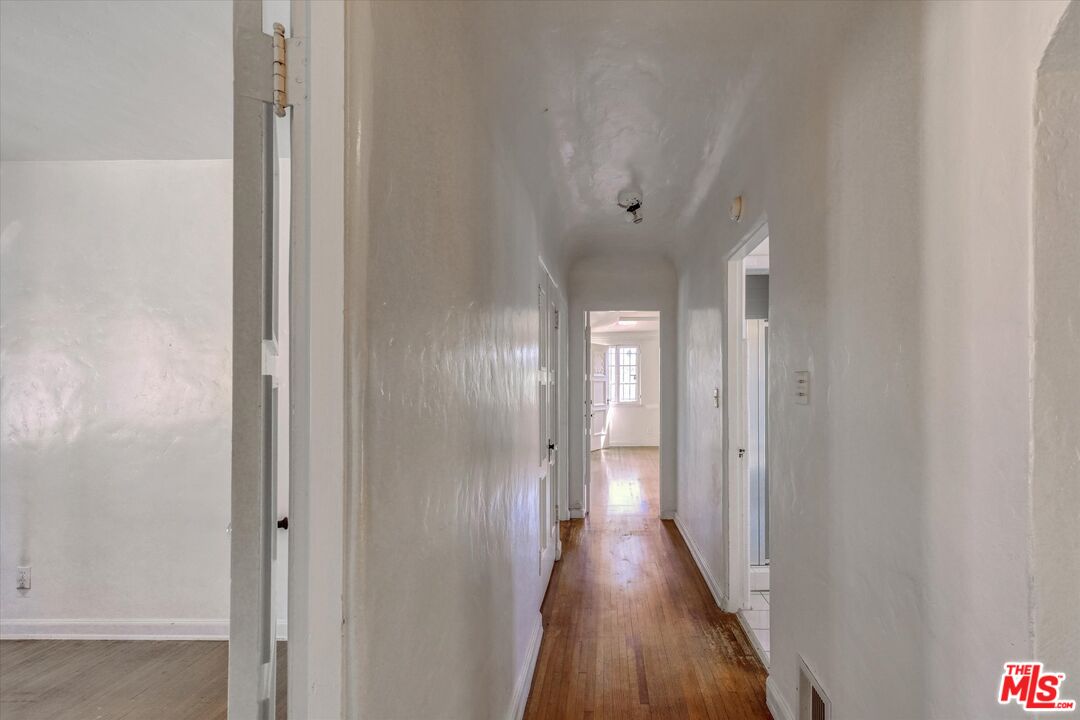 6220 Warner Drive Los Angeles, CA 90048 - Photo 31 of 44 a view of a hallway with wooden floor