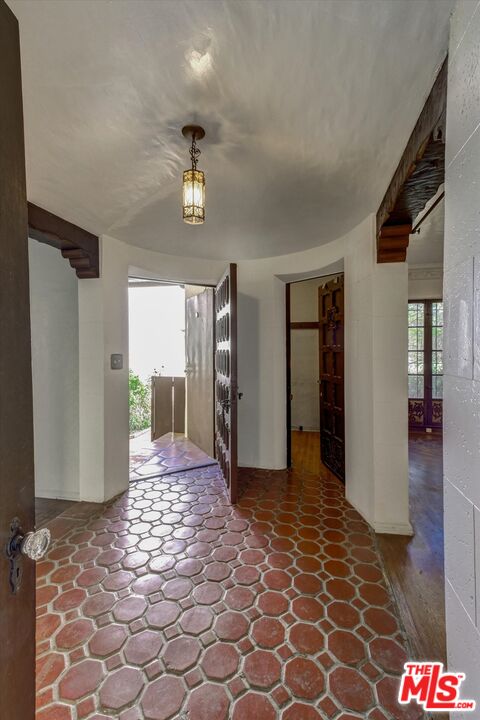 6220 Warner Drive Los Angeles, CA 90048 - Photo 7 of 44 a view of a hallway with wooden floor and a livingroom