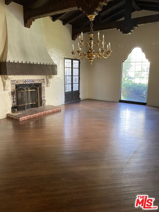 6220 Warner Drive Los Angeles, CA 90048 - Photo 9 of 44 an empty room with wooden floor and fireplace