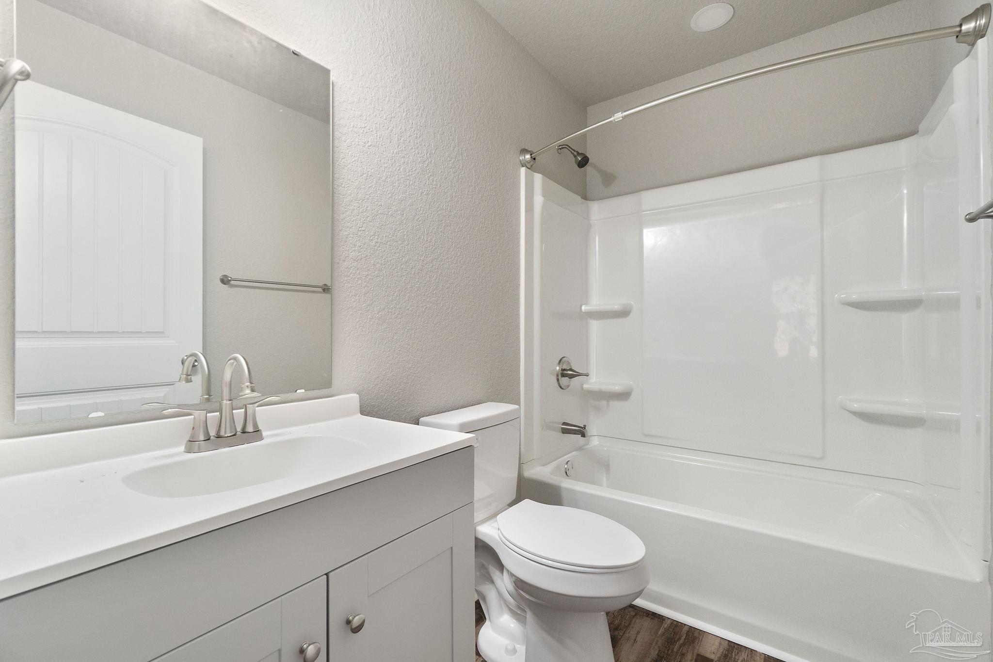 9906 Holsberry Road, Unit 101 Pensacola, FL 32534 - Photo 11 of 16 a bathroom with a sink a toilet and a bathtub