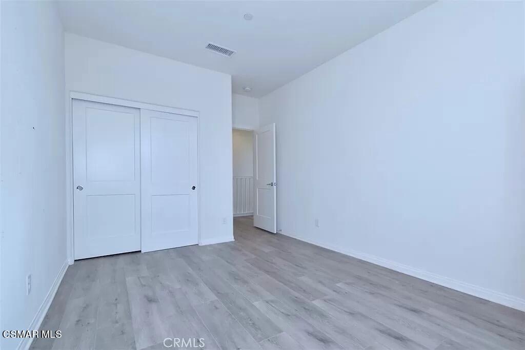 207 Morro Way, Unit 3 Simi Valley, CA 93065 - Photo 11 of 31 a view of an empty room with wooden floor